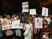 People hold placards as they attend the 'Droh carnival', a human-chain protest demonstration against the rape and murder of a junior doctor...