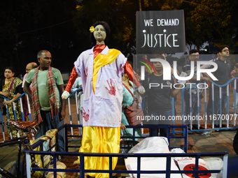 People stand behind an idol wearing a doctor's coat as they attend the 'Droh carnival', the human-chain protest demonstration against the ra...