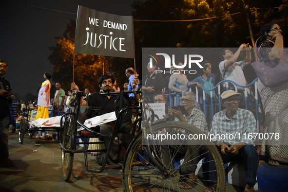 A financially challenged young boy holds a placard reading ''We Want Justice'' at the 'Droh Carnival', the human-chain protest demonstration...