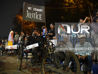 A financially challenged young boy holds a placard reading ''We Want Justice'' at the 'Droh Carnival', the human-chain protest demonstration...