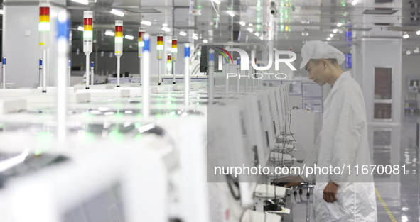 A worker produces an LED display at a workshop in Huai'an City, Jiangsu Province, China, on October 16, 2024. 