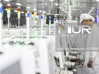 A worker produces an LED display at a workshop in Huai'an City, Jiangsu Province, China, on October 16, 2024. (