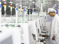 A worker produces an LED display at a workshop in Huai'an City, Jiangsu Province, China, on October 16, 2024. (