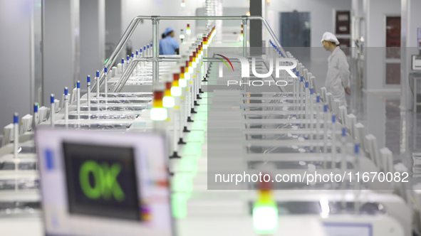 A worker produces an LED display at a workshop in Huai'an City, Jiangsu Province, China, on October 16, 2024. 