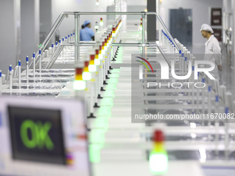 A worker produces an LED display at a workshop in Huai'an City, Jiangsu Province, China, on October 16, 2024. (