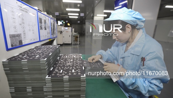 A worker produces an LED display at a workshop in Huai'an City, Jiangsu Province, China, on October 16, 2024. 