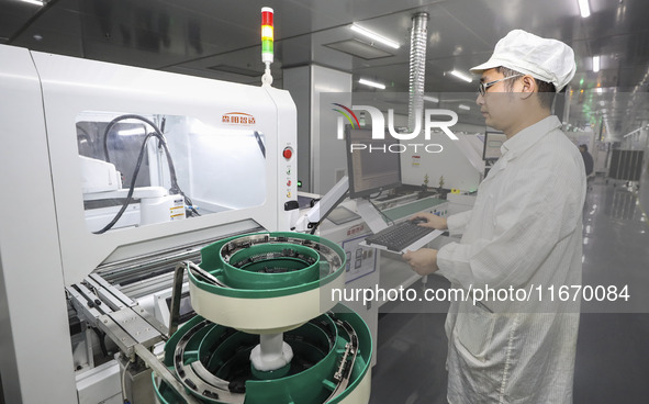 A worker produces an LED display at a workshop in Huai'an City, Jiangsu Province, China, on October 16, 2024. 