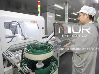 A worker produces an LED display at a workshop in Huai'an City, Jiangsu Province, China, on October 16, 2024. (