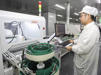 A worker produces an LED display at a workshop in Huai'an City, Jiangsu Province, China, on October 16, 2024. (