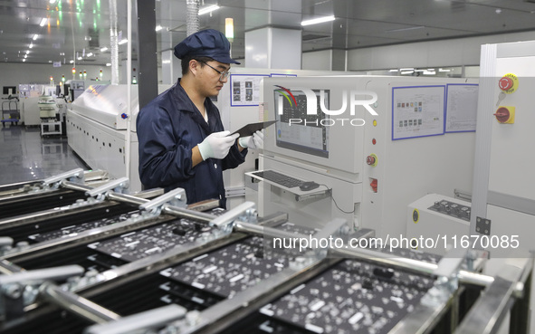 A worker produces an LED display at a workshop in Huai'an City, Jiangsu Province, China, on October 16, 2024. 