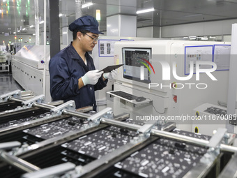 A worker produces an LED display at a workshop in Huai'an City, Jiangsu Province, China, on October 16, 2024. (