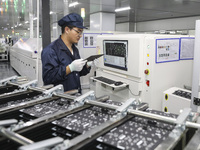 A worker produces an LED display at a workshop in Huai'an City, Jiangsu Province, China, on October 16, 2024. (