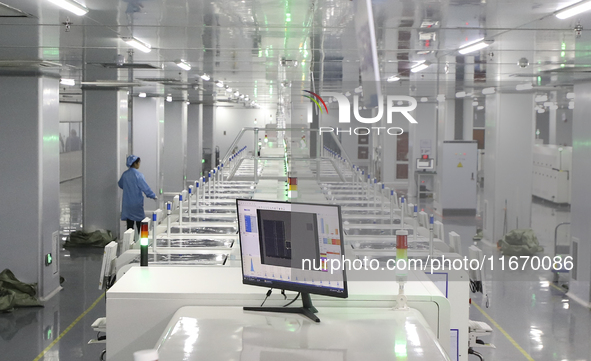 A worker produces an LED display at a workshop in Huai'an City, Jiangsu Province, China, on October 16, 2024. 