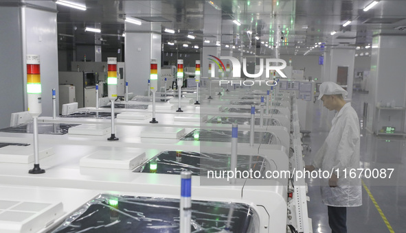 A worker produces an LED display at a workshop in Huai'an City, Jiangsu Province, China, on October 16, 2024. 