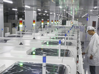 A worker produces an LED display at a workshop in Huai'an City, Jiangsu Province, China, on October 16, 2024. (