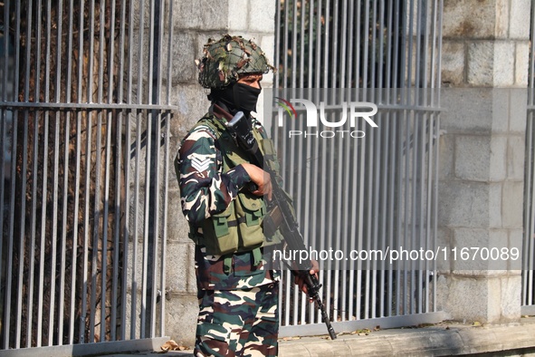 An Indian Paramilitary Soldier stands guard as Jammu and Kashmir and National Conference (NC) Vice President Omar Abdullah arrives to take t...