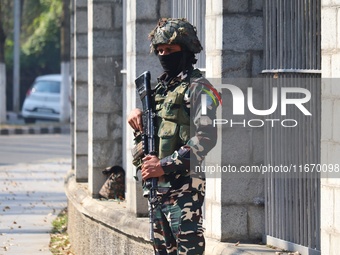 An Indian Paramilitary Soldier stands guard as Jammu and Kashmir and National Conference (NC) Vice President Omar Abdullah arrives to take t...