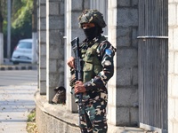 An Indian Paramilitary Soldier stands guard as Jammu and Kashmir and National Conference (NC) Vice President Omar Abdullah arrives to take t...