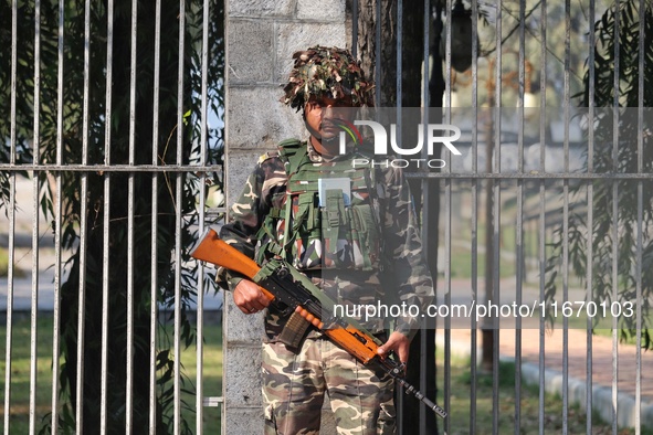 An Indian Paramilitary Soldier stands guard as Jammu and Kashmir and National Conference (NC) Vice President Omar Abdullah arrives to take t...