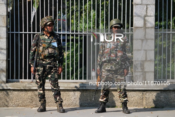 Indian paramilitary soldiers stand guard as Jammu and Kashmir and National Conference (NC) Vice President Omar Abdullah arrives to take the...