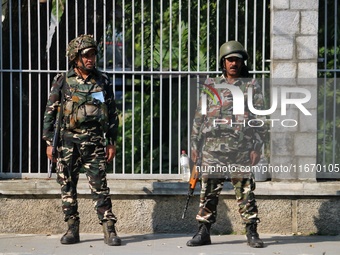 Indian paramilitary soldiers stand guard as Jammu and Kashmir and National Conference (NC) Vice President Omar Abdullah arrives to take the...