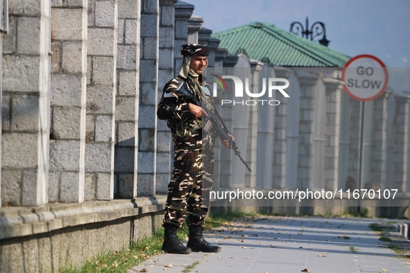 An Indian Paramilitary Soldier stands guard as Jammu and Kashmir and National Conference (NC) Vice President Omar Abdullah arrives to take t...