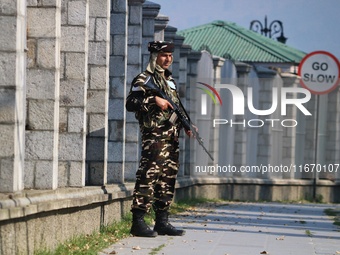 An Indian Paramilitary Soldier stands guard as Jammu and Kashmir and National Conference (NC) Vice President Omar Abdullah arrives to take t...