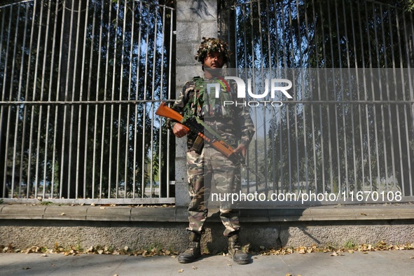 An Indian Paramilitary Soldier stands guard as Jammu and Kashmir and National Conference (NC) Vice President Omar Abdullah arrives to take t...