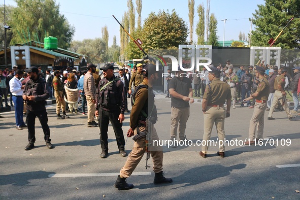 Indian policemen stand alert near the venue where Jammu and Kashmir and National Conference (NC) Vice President Omar Abdullah takes the oath...