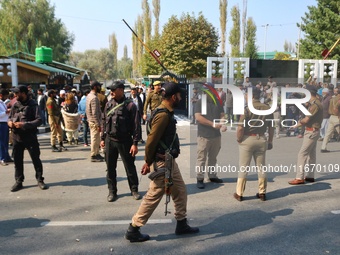 Indian policemen stand alert near the venue where Jammu and Kashmir and National Conference (NC) Vice President Omar Abdullah takes the oath...