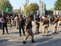 Indian policemen stand alert near the venue where Jammu and Kashmir and National Conference (NC) Vice President Omar Abdullah takes the oath...