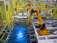 Workers produce solar photovoltaic module products at the workshop of GCL Integrated New Energy Technology Co., Ltd. in Hefei Circular Econo...