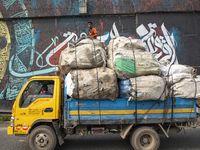 People walk past Arabic calligraphy in Dhaka, Bangladesh, on October 14, 2024. (