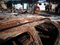 A displaced Palestinian girl looks out from a destroyed car due to an Israeli airstrike on the tents of the displaced inside the Al-Aqsa Mar...