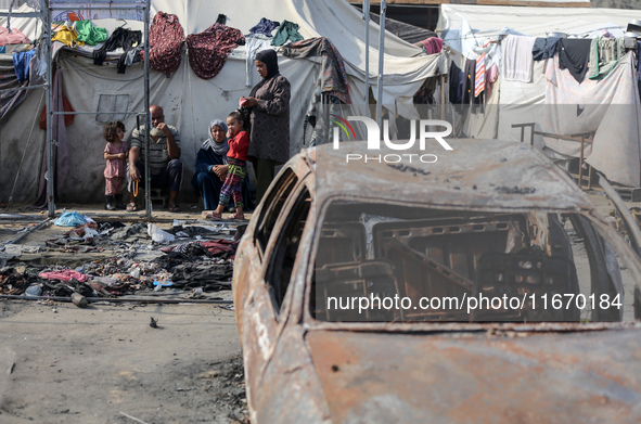 Palestinian displaced people are present at the site of an Israeli airstrike on the tents of the displaced inside the Al-Aqsa Martyrs Hospit...