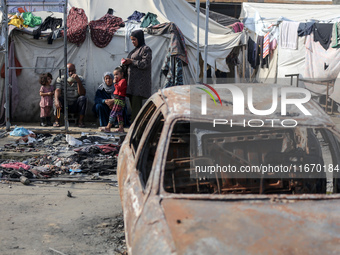 Palestinian displaced people are present at the site of an Israeli airstrike on the tents of the displaced inside the Al-Aqsa Martyrs Hospit...