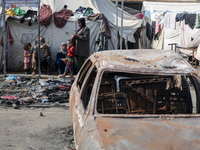 Palestinian displaced people are present at the site of an Israeli airstrike on the tents of the displaced inside the Al-Aqsa Martyrs Hospit...