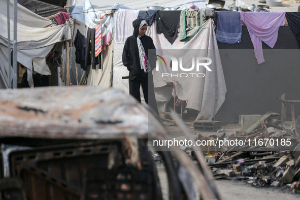 Palestinian displaced people are present at the site of an Israeli airstrike on the tents of the displaced inside the Al-Aqsa Martyrs Hospit...