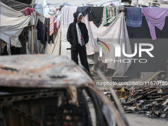 Palestinian displaced people are present at the site of an Israeli airstrike on the tents of the displaced inside the Al-Aqsa Martyrs Hospit...