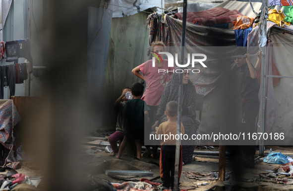 Palestinian displaced people are present at the site of an Israeli airstrike on the tents of the displaced inside the Al-Aqsa Martyrs Hospit...