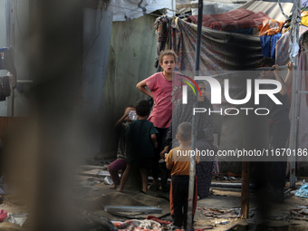 Palestinian displaced people are present at the site of an Israeli airstrike on the tents of the displaced inside the Al-Aqsa Martyrs Hospit...