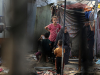 Palestinian displaced people are present at the site of an Israeli airstrike on the tents of the displaced inside the Al-Aqsa Martyrs Hospit...