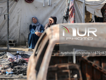 Palestinian displaced people are present at the site of an Israeli airstrike on the tents of the displaced inside the Al-Aqsa Martyrs Hospit...