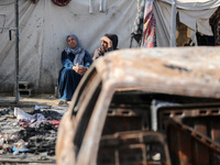 Palestinian displaced people are present at the site of an Israeli airstrike on the tents of the displaced inside the Al-Aqsa Martyrs Hospit...