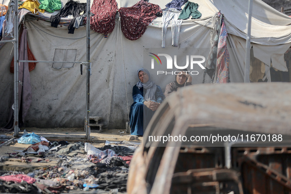 Palestinian displaced people are present at the site of an Israeli airstrike on the tents of the displaced inside the Al-Aqsa Martyrs Hospit...