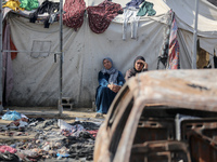 Palestinian displaced people are present at the site of an Israeli airstrike on the tents of the displaced inside the Al-Aqsa Martyrs Hospit...