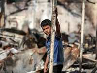 Palestinian displaced people are present at the site of an Israeli airstrike on the tents of the displaced inside the Al-Aqsa Martyrs Hospit...