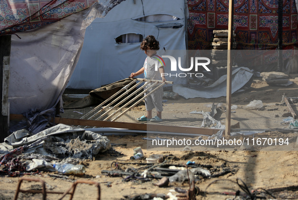 Palestinian displaced people are present at the site of an Israeli airstrike on the tents of the displaced inside the Al-Aqsa Martyrs Hospit...