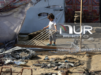 Palestinian displaced people are present at the site of an Israeli airstrike on the tents of the displaced inside the Al-Aqsa Martyrs Hospit...