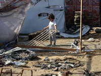 Palestinian displaced people are present at the site of an Israeli airstrike on the tents of the displaced inside the Al-Aqsa Martyrs Hospit...